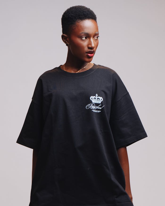 Chic portrait of a woman wearing a black t-shirt with regal crown design.